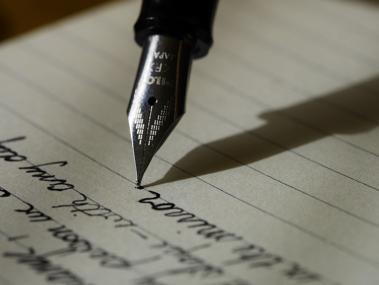 Photo of a fountain pen and writing