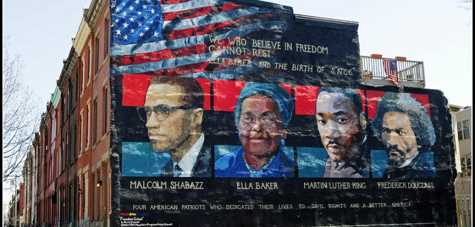 Mural on the wall of row houses in Philadelphia. The artist is Parris Stancell, sponsored by the Freedom School Mural Arts Program. Left to right; Malcolm Shabazz (Malcolm X), Ella Baker, Martin Luther King, Frederick Douglass.