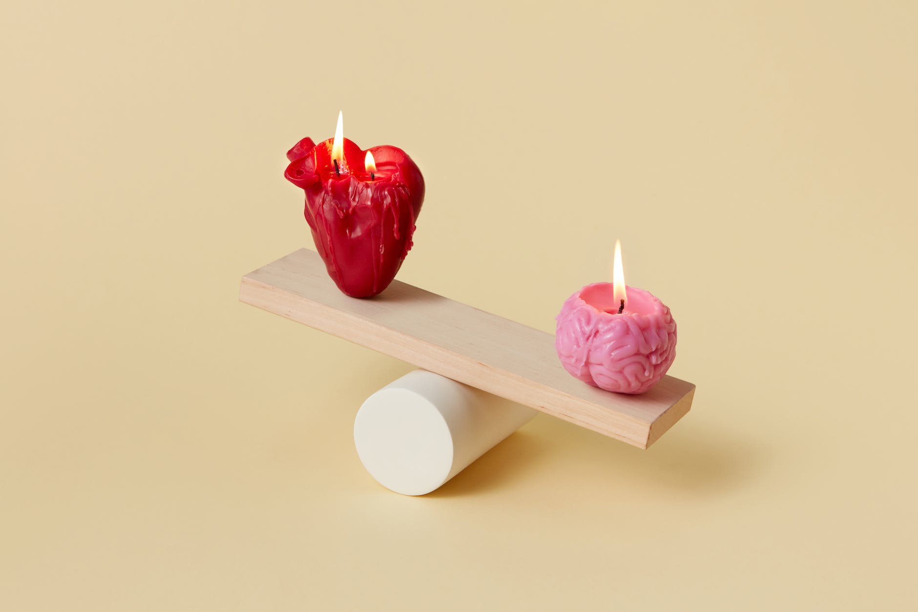 burning heart and brain candles on a wooden lever