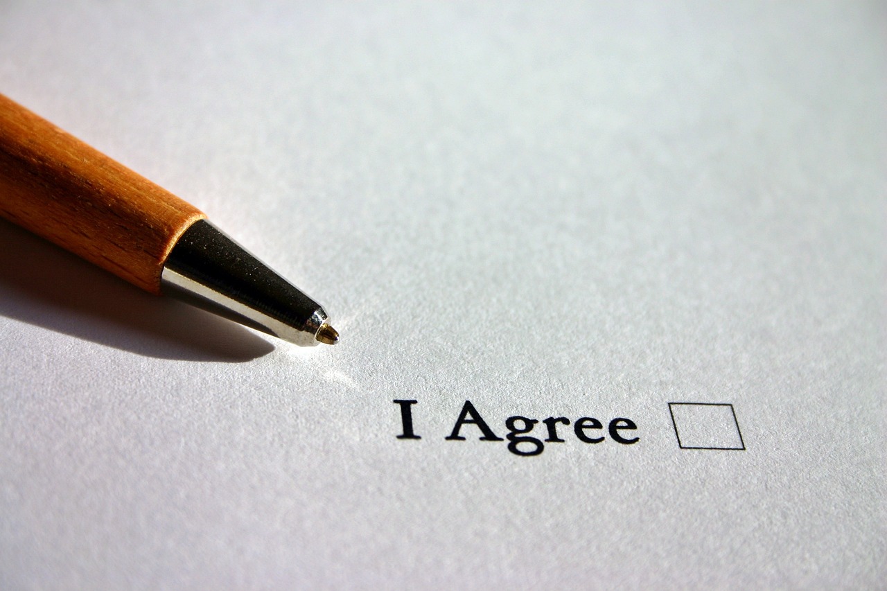 decorative image; a pen besides a check box that says "I agree"
