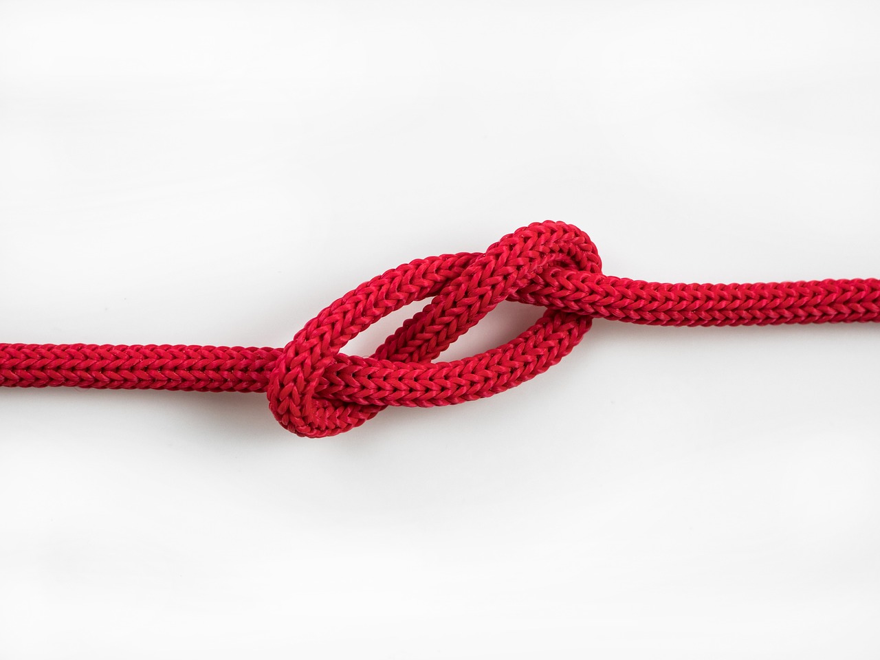 Red tied knot against white background