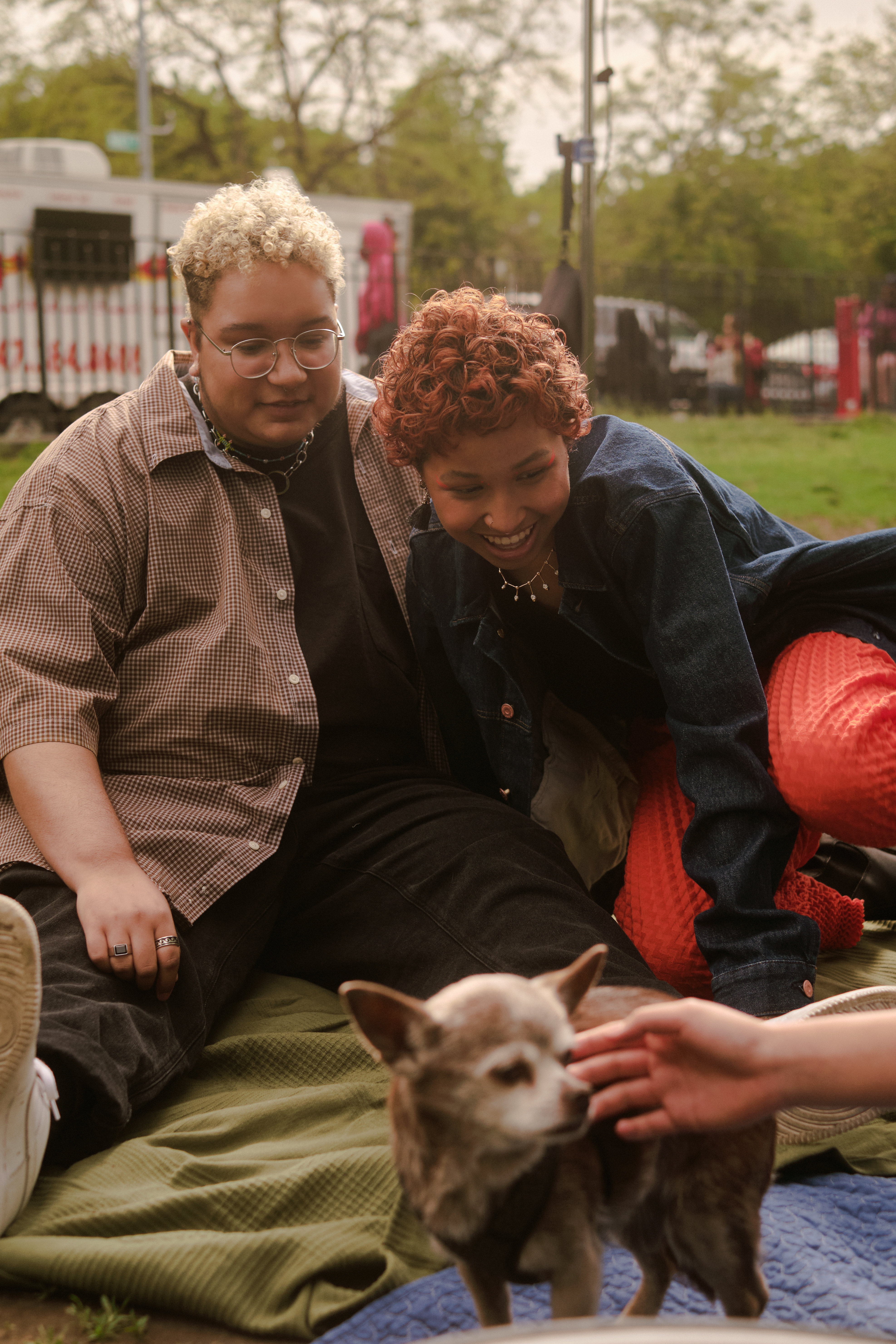 two people in a park with a dog