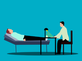 Cartoon of patient lying on a couch with a therapist sat at a desk nearby.