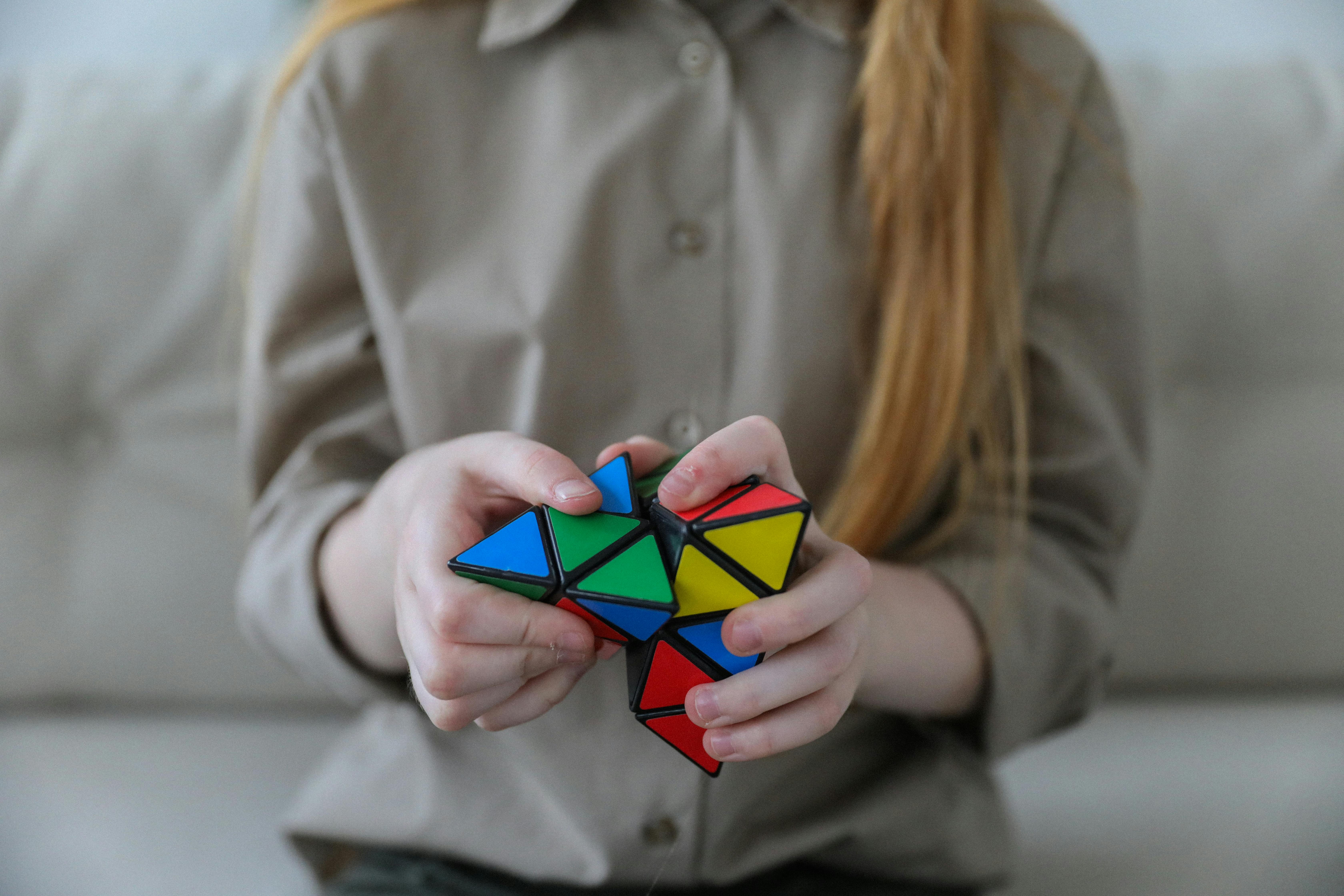 torso of a woman holding rubik's cube style game