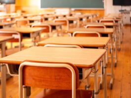 A picture of school desks lined up in a row